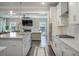 Open-concept kitchen with stainless steel appliances seamlessly flows into the living room with a fireplace at 4332 John Hatch Dr, Johns Island, SC 29455
