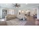 Open-concept living room with hardwood floors, a large sectional, and a view of the kitchen at 4332 John Hatch Dr, Johns Island, SC 29455