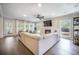 Spacious living room featuring a cozy fireplace, large windows, and a comfortable sectional sofa at 4332 John Hatch Dr, Johns Island, SC 29455