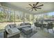 Relaxing screened porch has comfortable seating, a ceiling fan, and views of the backyard at 4332 John Hatch Dr, Johns Island, SC 29455