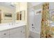 Bright bathroom featuring a white vanity, framed mirror, and a shower-tub combination with decorative curtain at 4338 Sea Forest Dr, Kiawah Island, SC 29455