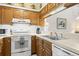 Well-lit kitchen with wood cabinets, white countertops, and modern appliances at 4338 Sea Forest Dr, Kiawah Island, SC 29455