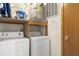 Laundry room features a washing machine, dryer, water heater, overhead cabinets, and closet space at 4338 Sea Forest Dr, Kiawah Island, SC 29455