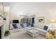 Bright living room with vaulted ceilings, comfortable seating, and a view to the outdoor patio at 4338 Sea Forest Dr, Kiawah Island, SC 29455