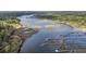 Scenic aerial view of a riverfront property with private docks and lush surrounding greenery at 4584 Olde Smoak House Rd, Meggett, SC 29449