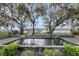 Wide outdoor shot of a backyard fish pond, with waterfront views framed by trees at 4584 Olde Smoak House Rd, Meggett, SC 29449