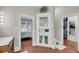 A bright bathroom with a corner cabinet and views into the main bedroom at 4584 Olde Smoak House Rd, Meggett, SC 29449