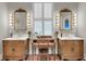 A bright bathroom with dual vanities, a makeup area, and large windows at 4584 Olde Smoak House Rd, Meggett, SC 29449