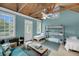 Light-filled bedroom featuring multiple beds, rustic wood ceilings, and an inviting atmosphere at 4584 Olde Smoak House Rd, Meggett, SC 29449