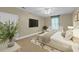 Inviting bedroom with neutral tones, a large bed, seating area, and natural light at 4584 Olde Smoak House Rd, Meggett, SC 29449