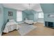 Cozy bedroom with twin beds, charming decor, and natural light from the windows at 4584 Olde Smoak House Rd, Meggett, SC 29449
