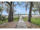 Picturesque wooden dock with lush trees and Spanish moss that provides direct access to the waterfront at 4584 Olde Smoak House Rd, Meggett, SC 29449