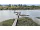 Well-maintained dock extends into the water, perfect for boating, fishing, and enjoying waterfront activities at 4584 Olde Smoak House Rd, Meggett, SC 29449