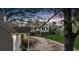 Charming two-story home featuring a picturesque wrap-around porch and a long, winding driveway through a lush, landscaped yard at 4584 Olde Smoak House Rd, Meggett, SC 29449