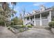 Charming two-story home with a spacious porch, well-maintained landscaping, and unique backyard water feature at 4584 Olde Smoak House Rd, Meggett, SC 29449