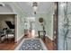 Elegant foyer featuring a grand piano, decorative rug, and views of other rooms at 4584 Olde Smoak House Rd, Meggett, SC 29449
