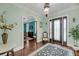 Grand foyer with dark wood floors, a statement rug, and ample natural light at 4584 Olde Smoak House Rd, Meggett, SC 29449