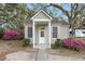 Charming cottage-style home with inviting front porch, beautiful landscaping, and quaint curb appeal at 4584 Olde Smoak House Rd, Meggett, SC 29449