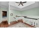 Hallway landing with a ceiling fan, area rug and access to multiple rooms at 4584 Olde Smoak House Rd, Meggett, SC 29449