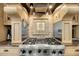 Gourmet kitchen featuring custom hood and stainless steel gas range at 4584 Olde Smoak House Rd, Meggett, SC 29449