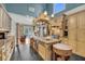 A spacious kitchen featuring custom cabinets, a large island, and a pot rack over the island with modern appliances at 4584 Olde Smoak House Rd, Meggett, SC 29449