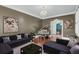Stylish living room featuring comfortable sofas, a grand piano, and elegant decor at 4584 Olde Smoak House Rd, Meggett, SC 29449