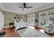A spacious main bedroom with hardwood floors, a ceiling fan, and access to a balcony with beautiful views at 4584 Olde Smoak House Rd, Meggett, SC 29449
