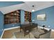 This stylish office features a large desk, bookshelf, and chair on a decorative rug with a blue wall at 4584 Olde Smoak House Rd, Meggett, SC 29449