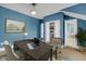 This warm office features a large desk, chair, and natural lighting from a window, and blue walls at 4584 Olde Smoak House Rd, Meggett, SC 29449
