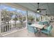 Open-air patio boasts lake views, seating, ceiling fans and white pillars at 4584 Olde Smoak House Rd, Meggett, SC 29449