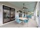 Covered patio with blue furniture, ceiling fans, pillars, and sliding doors to the interior at 4584 Olde Smoak House Rd, Meggett, SC 29449