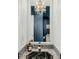 Close up view of the powder room mirror, vanity, and sink at 4584 Olde Smoak House Rd, Meggett, SC 29449