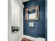 Chic powder room with designer mirror, unique sink, and stylish blue walls at 4584 Olde Smoak House Rd, Meggett, SC 29449