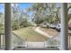 Picturesque view from the porch featuring sprawling grounds, a charming guest house, and beautiful mature trees at 4584 Olde Smoak House Rd, Meggett, SC 29449