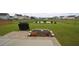 A spacious backyard featuring a patio, lawn, and a view of a pond at 470 Spectrum Rd, Summerville, SC 29486