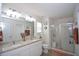 Bright bathroom features double sinks, granite countertops, and a glass-enclosed shower at 470 Spectrum Rd, Summerville, SC 29486