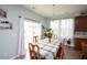 Bright dining area with large windows, sliding door, decorative chandelier, and wood-look tile at 470 Spectrum Rd, Summerville, SC 29486