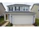 Two-story home features a well-maintained front yard, a two-car garage, and blue vinyl siding at 470 Spectrum Rd, Summerville, SC 29486