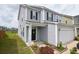 Two-story home featuring a well-maintained front yard, and a two-car garage with gray vinyl siding at 470 Spectrum Rd, Summerville, SC 29486