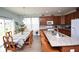 Open-concept kitchen with granite island, seating, stainless sink, and adjoining dining area at 470 Spectrum Rd, Summerville, SC 29486