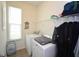 Functional laundry room with a washer, dryer, and storage shelving at 470 Spectrum Rd, Summerville, SC 29486