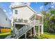 Exterior rear view of a home featuring a deck and screened in porch above the shaded backyard space at 5035 Gum Tree Ln, Johns Island, SC 29455