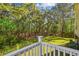 Backyard view from deck overlooking trees and green space creating a private and serene atmosphere at 5035 Gum Tree Ln, Johns Island, SC 29455