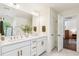 Well-lit bathroom featuring a double vanity, modern fixtures, and ample counter space at 5035 Gum Tree Ln, Johns Island, SC 29455