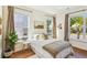 Bright bedroom with natural light from multiple windows, complete with hardwood floors and stylish decor at 5035 Gum Tree Ln, Johns Island, SC 29455