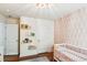 Well-organized Bedroom featuring a crib, book shelves, and two white paneled doors at 5035 Gum Tree Ln, Johns Island, SC 29455
