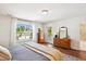 Bright bedroom featuring gleaming hardwood floors, a dresser, and large windows overlooking the street at 5035 Gum Tree Ln, Johns Island, SC 29455
