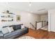 Bright bonus room with hardwood floors, decor shelves and a comfortable gray sofa at 5035 Gum Tree Ln, Johns Island, SC 29455