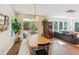 Sunlit dining room features hardwood floors, a hutch, and flows into the living area at 5035 Gum Tree Ln, Johns Island, SC 29455