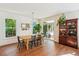 Bright dining room with hardwood floors, modern light fixture, and access to outdoor patio at 5035 Gum Tree Ln, Johns Island, SC 29455